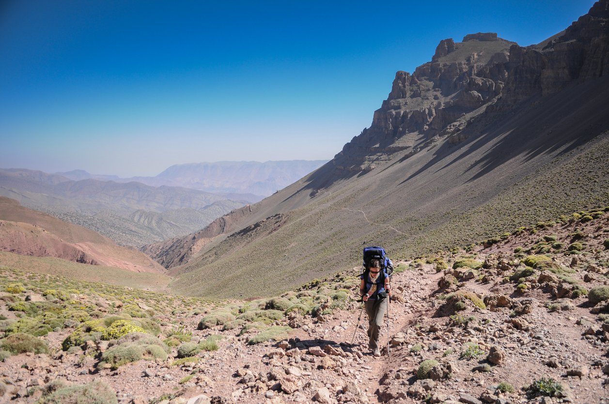A female hiker trekking in Morocco's High Atlas mountains.