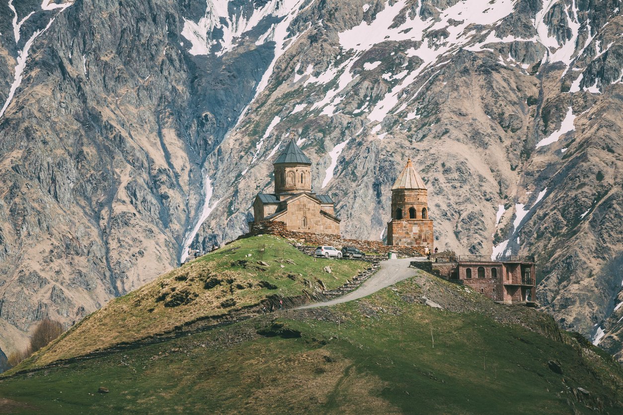 The Gergeti Trinity church with a stunning mountain backdrop behind.