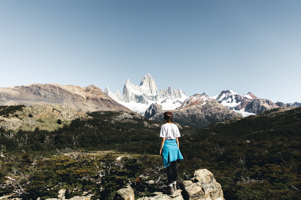 A hiker standing below Mount Fitz Roy, in Torres del Paine national park.