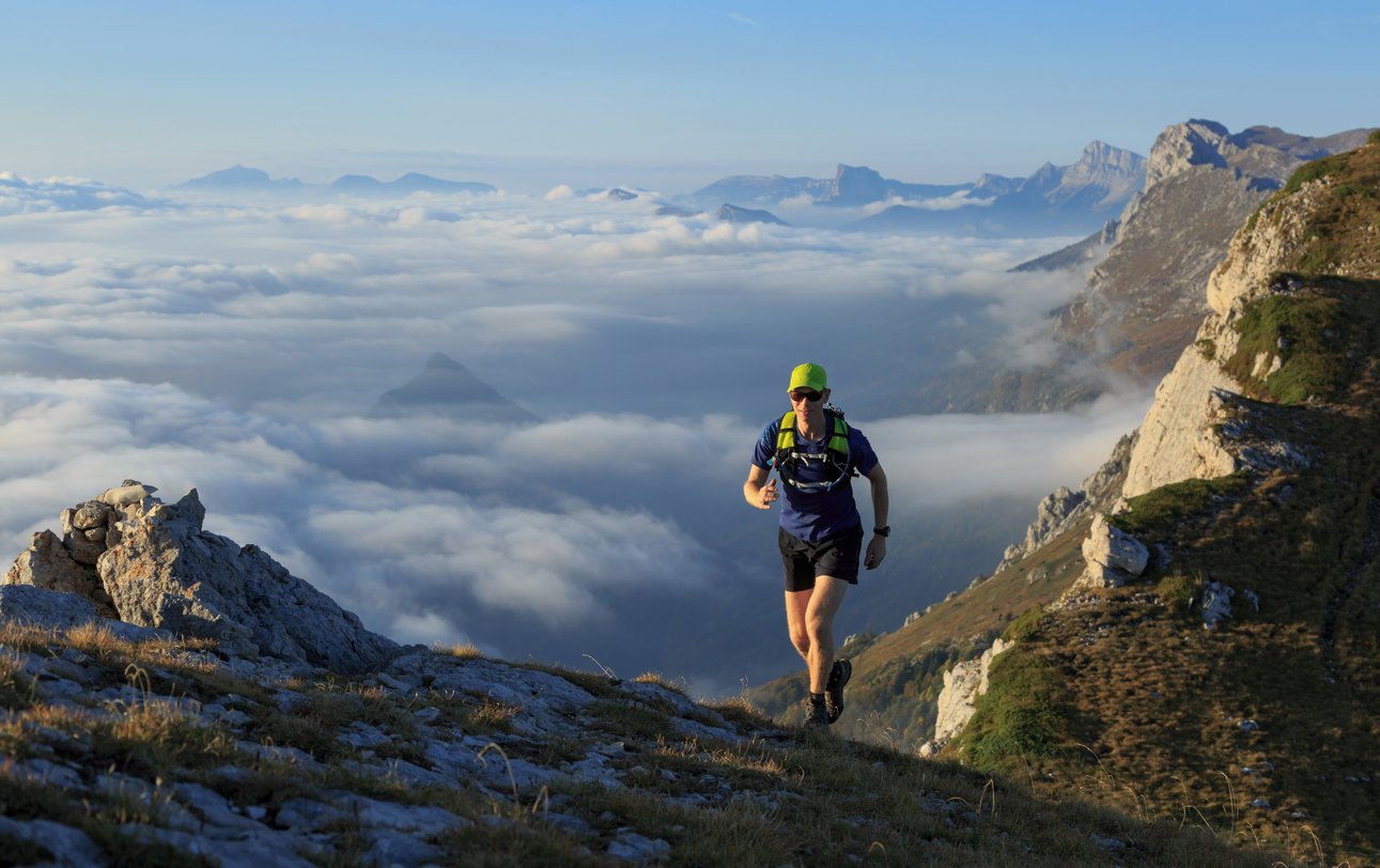 A man trail running in the mountains of Vercor, France.