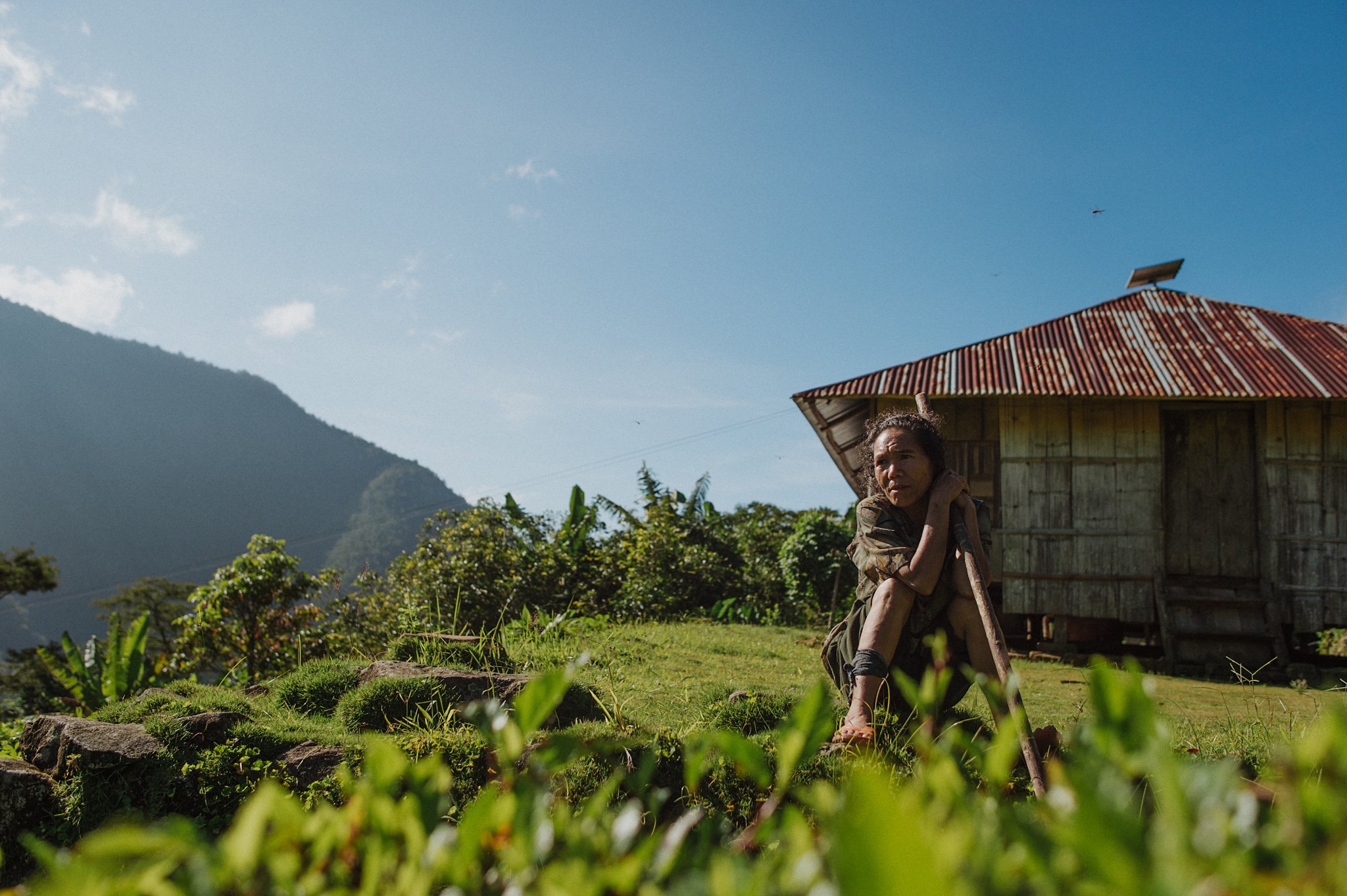 A villager looks out over the view of the valley in Wae Rebo, Indonesia.