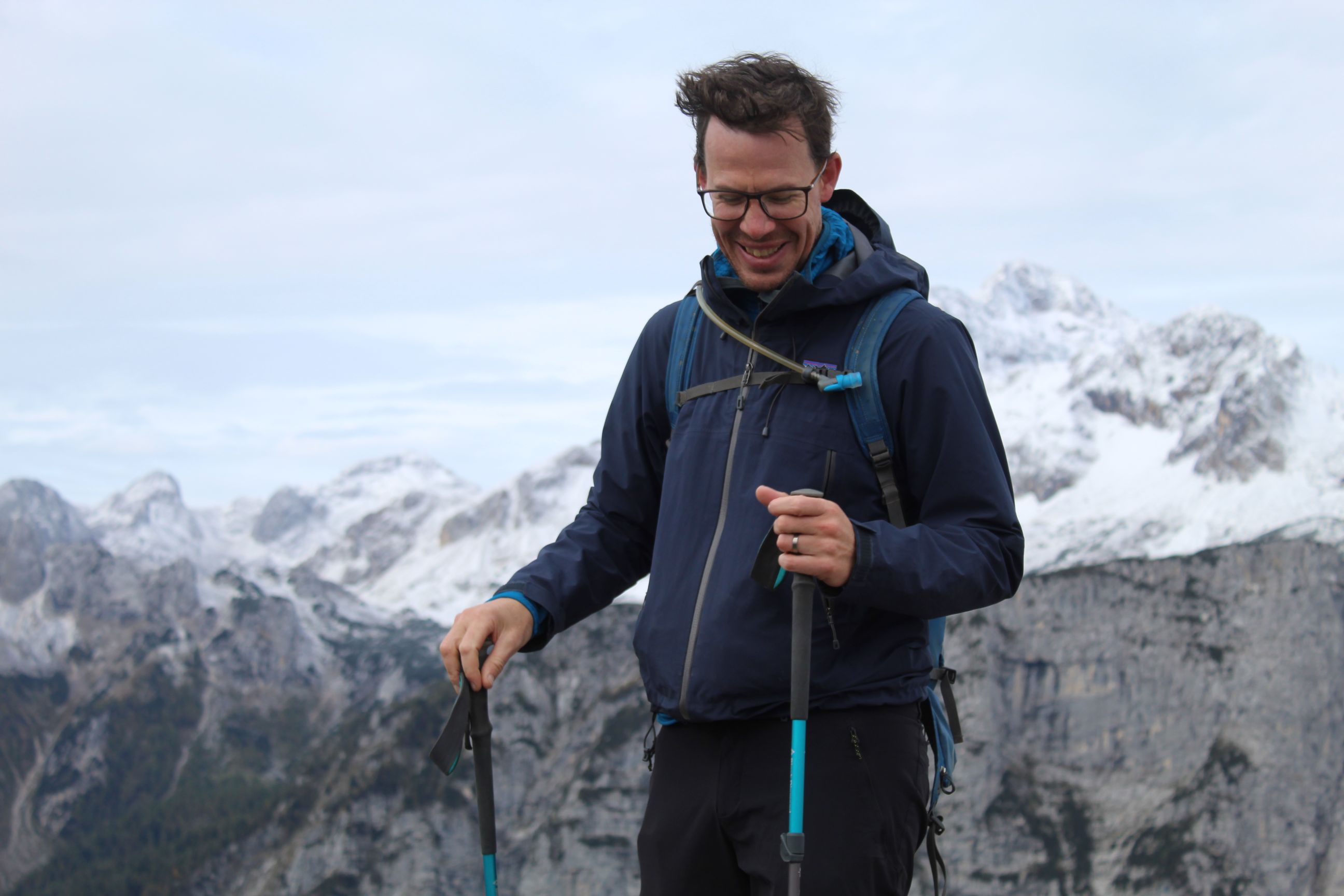 Guy on top of a mountain with Triglav in the background.