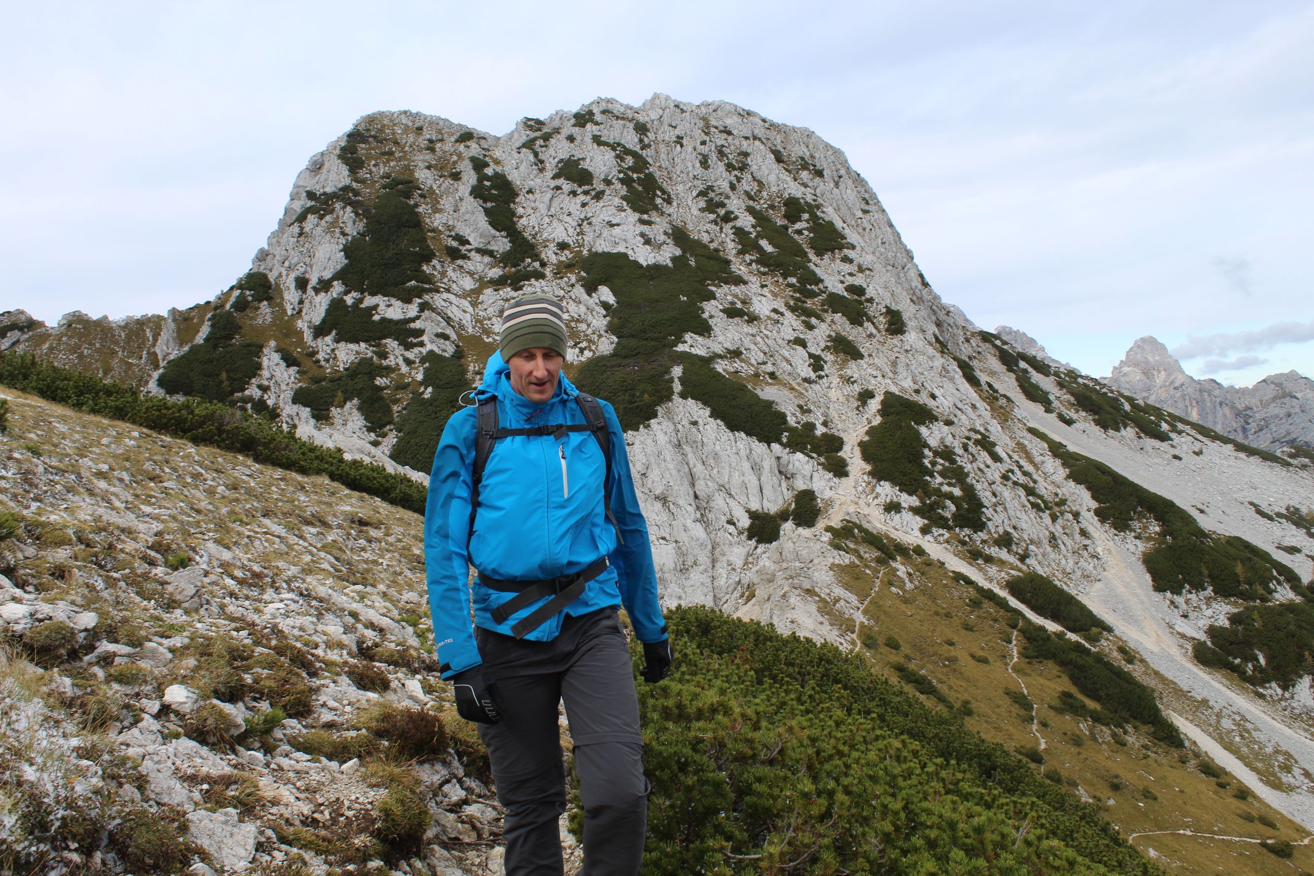 A man hiking along the ridgeline of Lipanski vrh, a mountain in Slovenia.