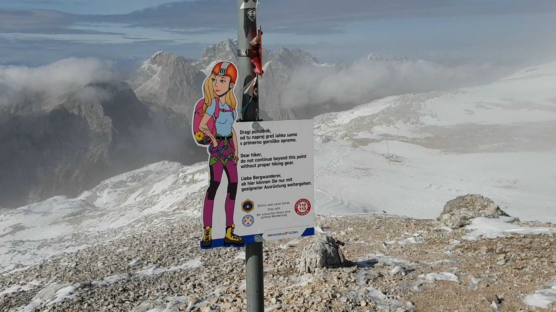 A sign in Slovenia at the start of a via ferrata route, showing appropriate kit 