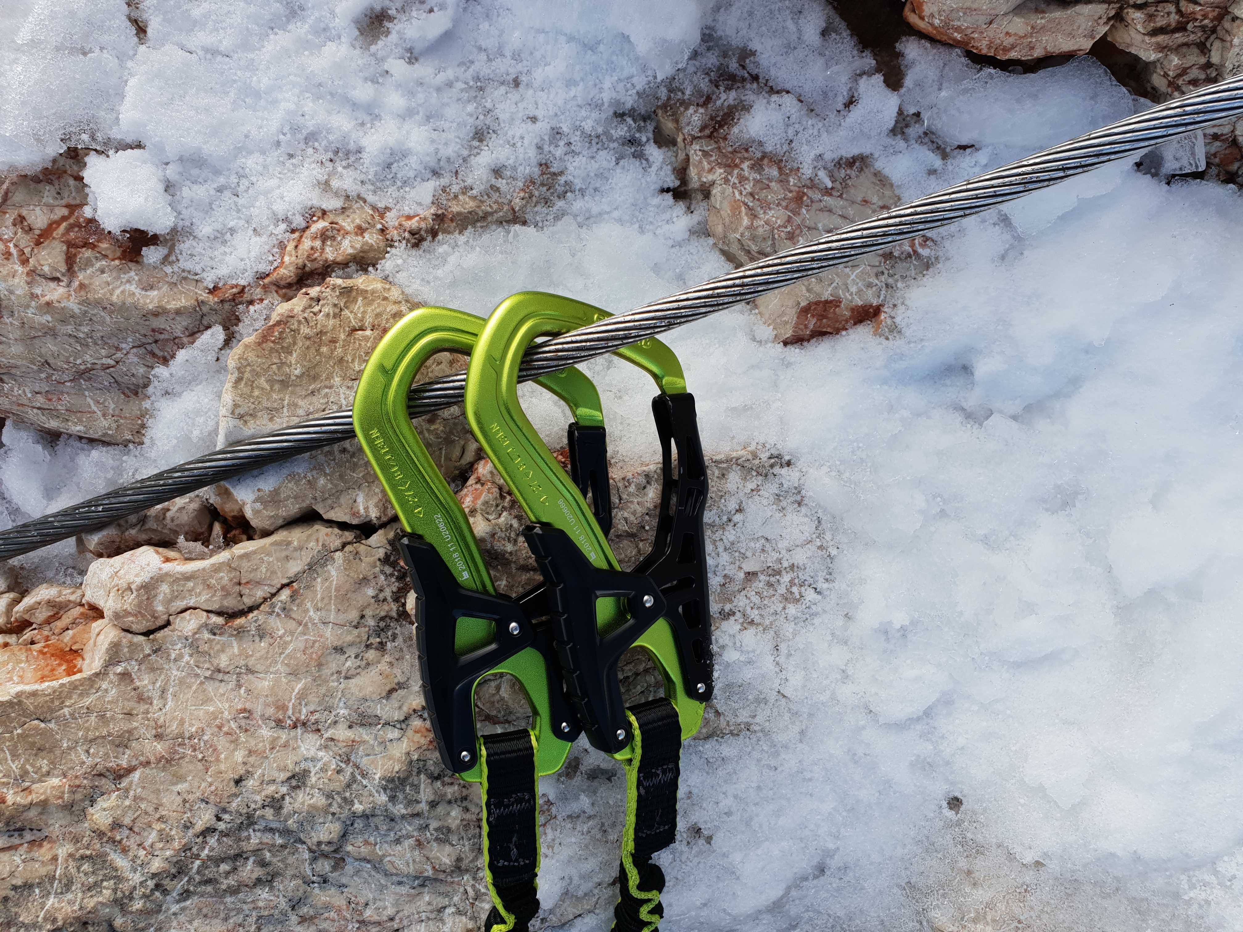 What is via ferrata? A guide. Here, Karabiners from a via ferrata lanyard clipped into a metal wire