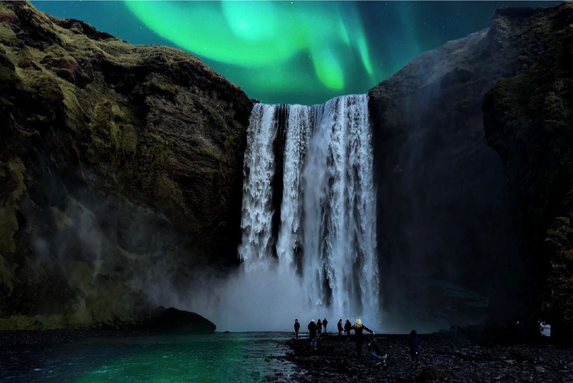 A stunning waterfall beneath the northern lights. 