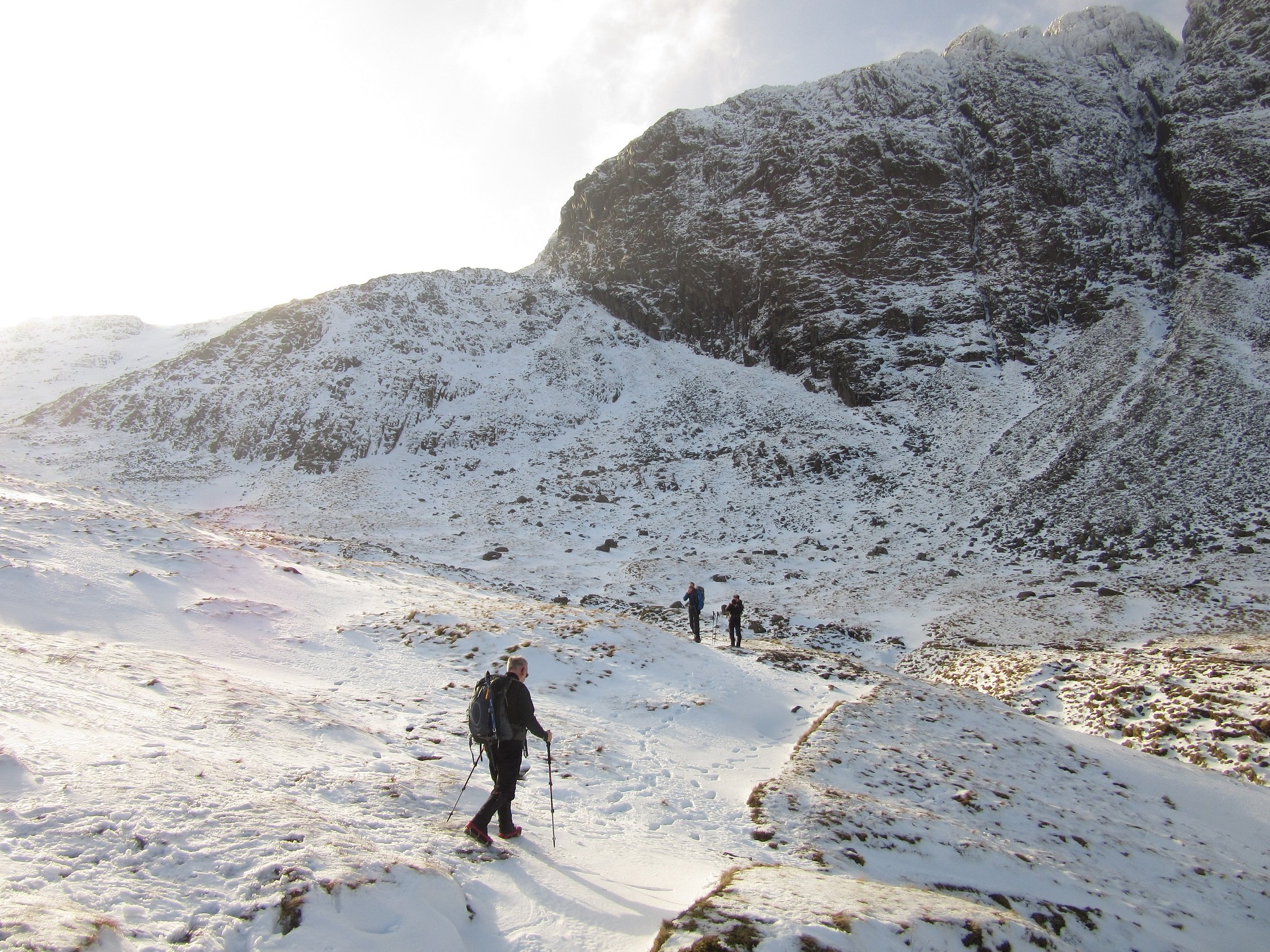 Hikers on the path up Scafell Pike from Borrowdale, on a snowy day.