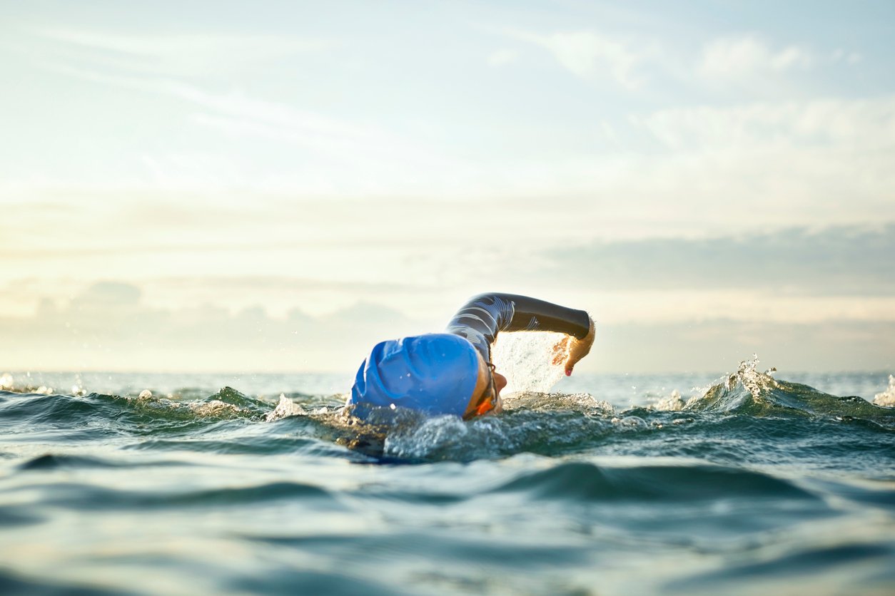 An open water swimmer doing front crawl in the sea