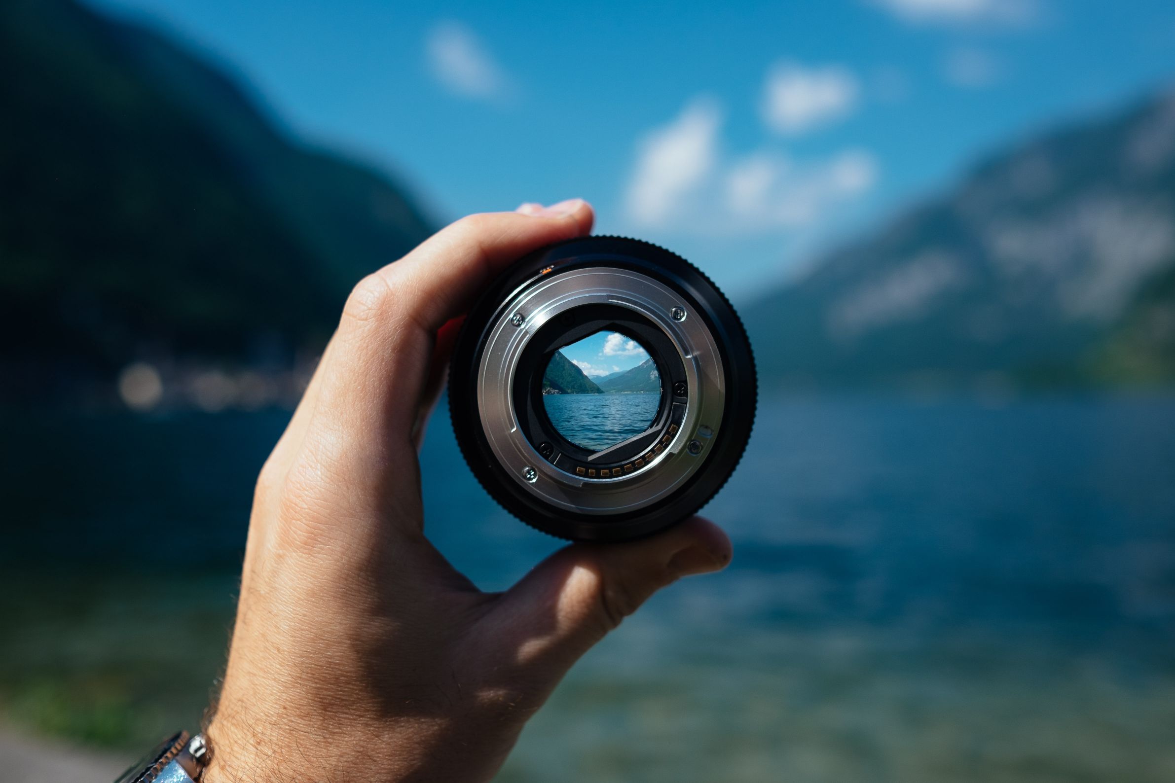 the camera lens of an outdoor photographer looking on to the fjords