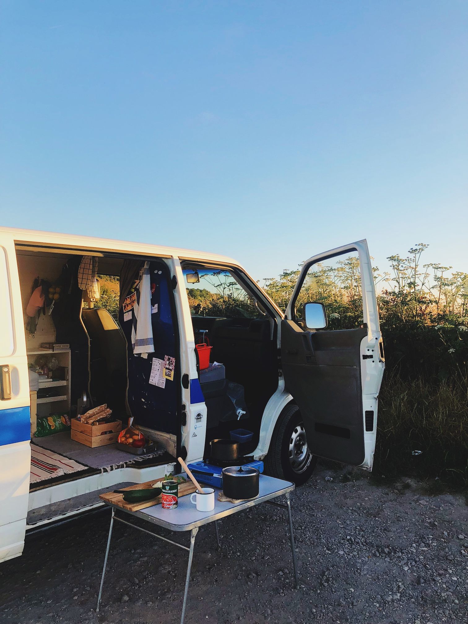 A quintessential van life capture, with pots and pans ready to cook for dinner