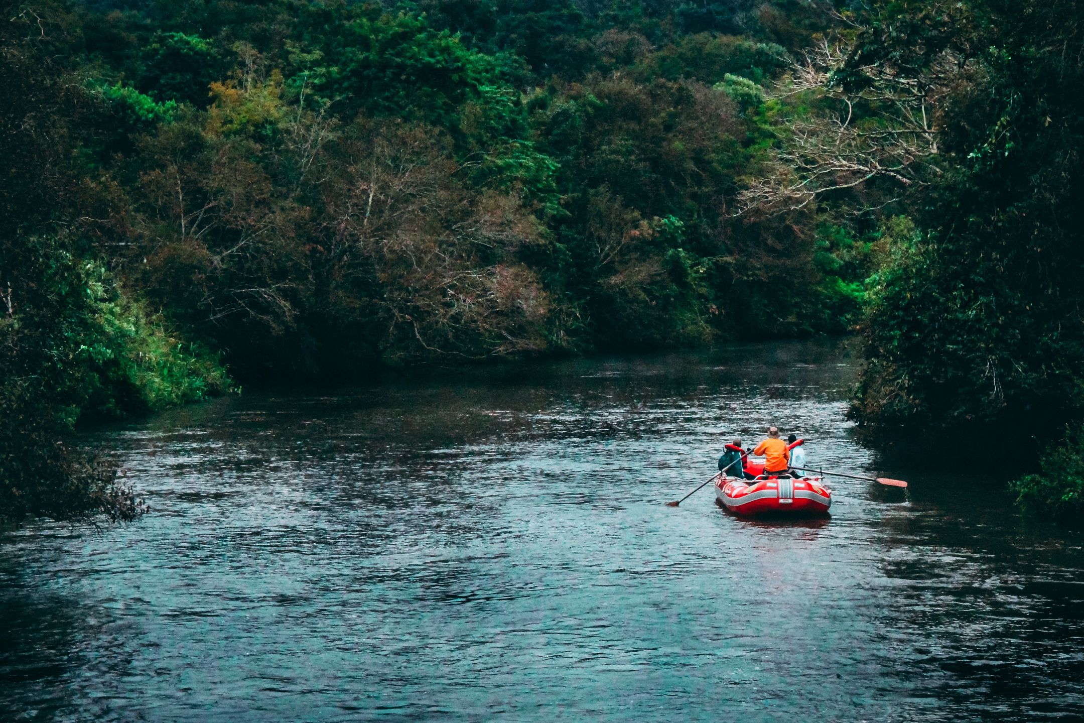 People rafting on a calm river in the UK.