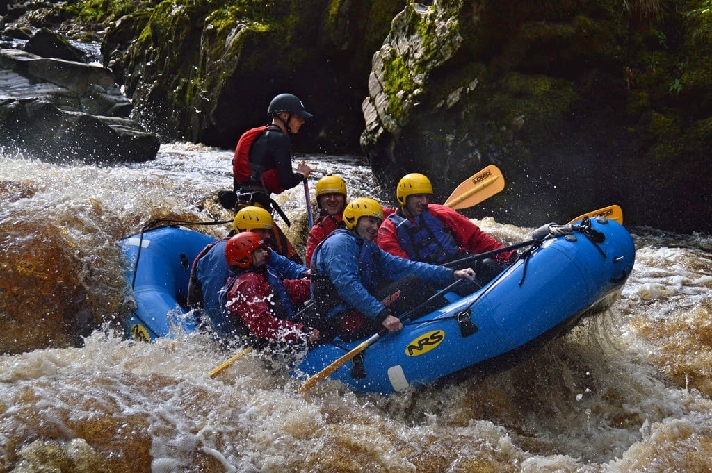 People going white water rafting on the Findhorn River, in the Cairngorms National Park.