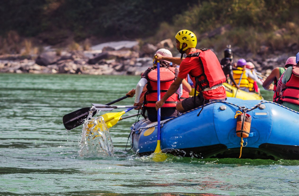 People white water rafting down a river in Northern Ireland