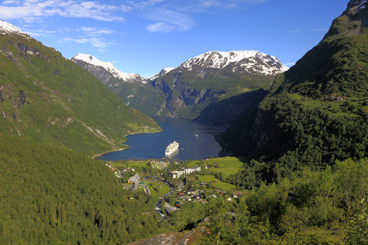 View of Geiranger with a boat in the fjord beyond.