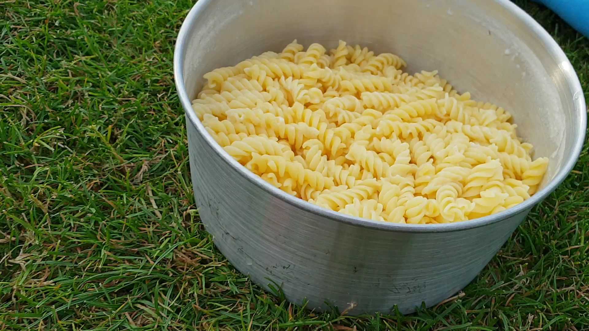 A camping pan filled with pasta.