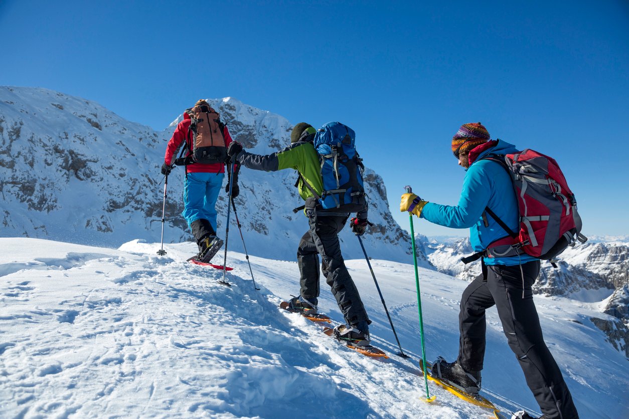 Three hikers snow-shoeing in the Julian Alps.