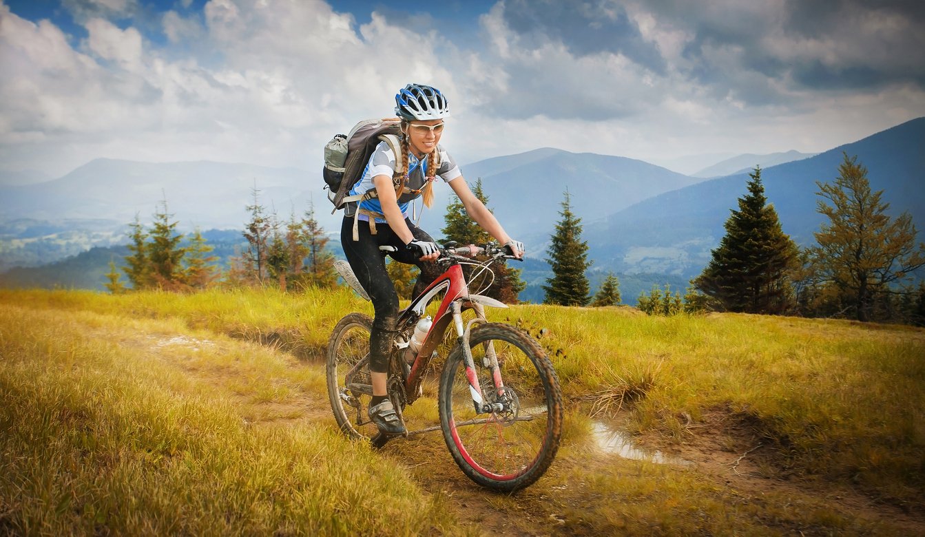A female cyclist riding a mountain bike in the Carpathian Mountains