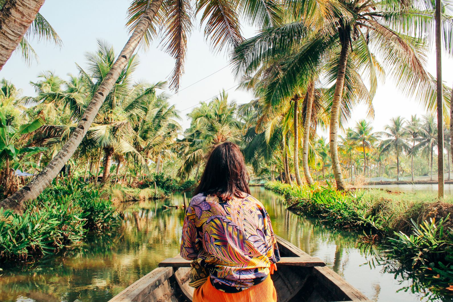 A woman in a boat through the Kerala backwaters.
