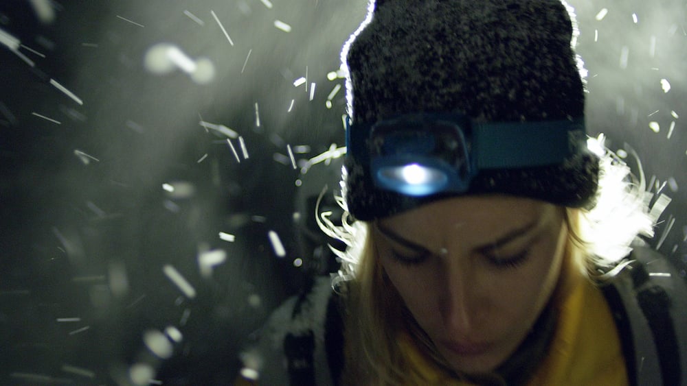 A woman using a headtorch.