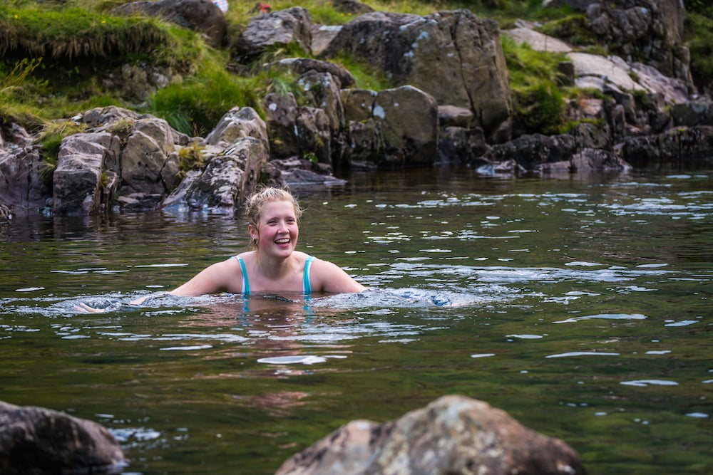 A female wild swimmer in a river.