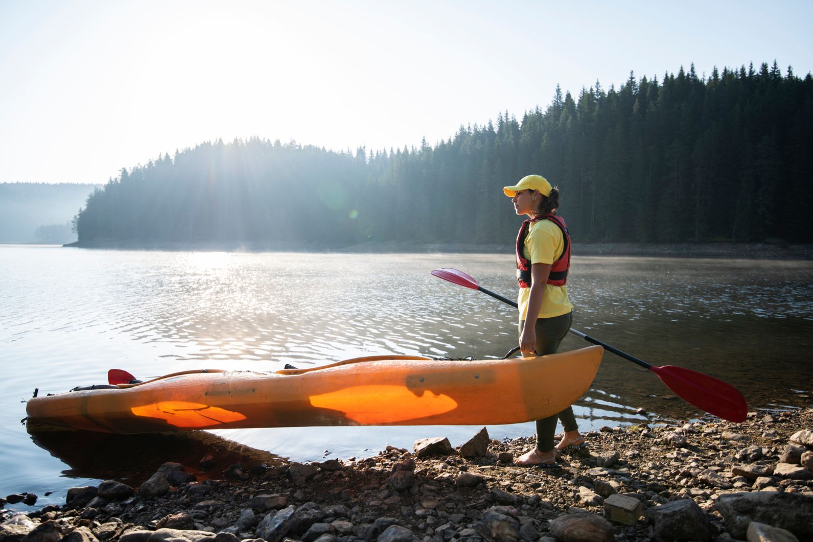 Woman kayaker about to launch a double kayak