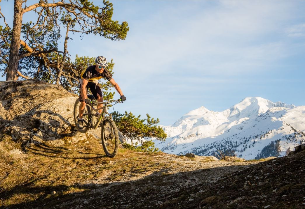 A man mountain biking in the French Alps.