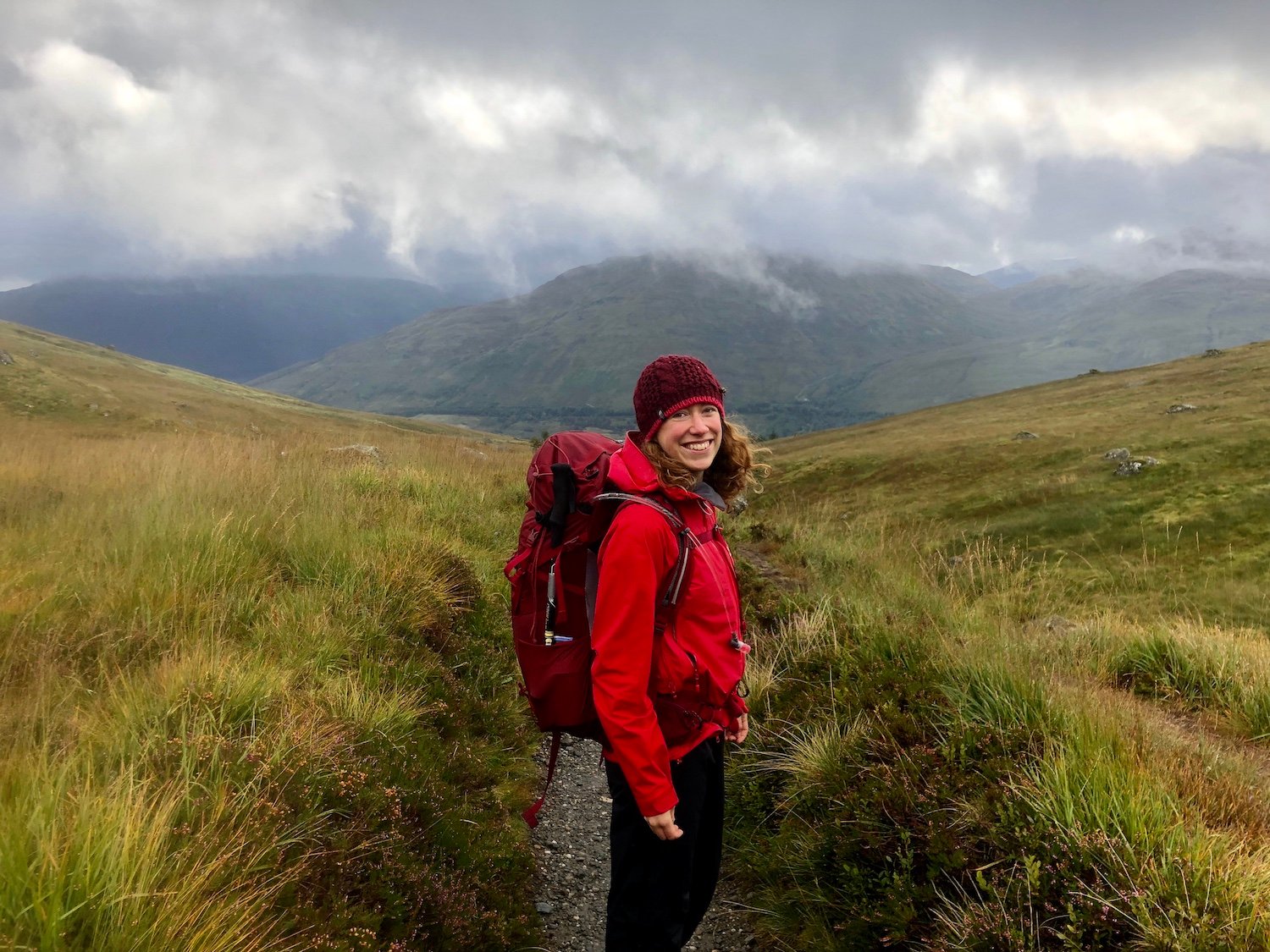 A woman hiking on a cloudy day.