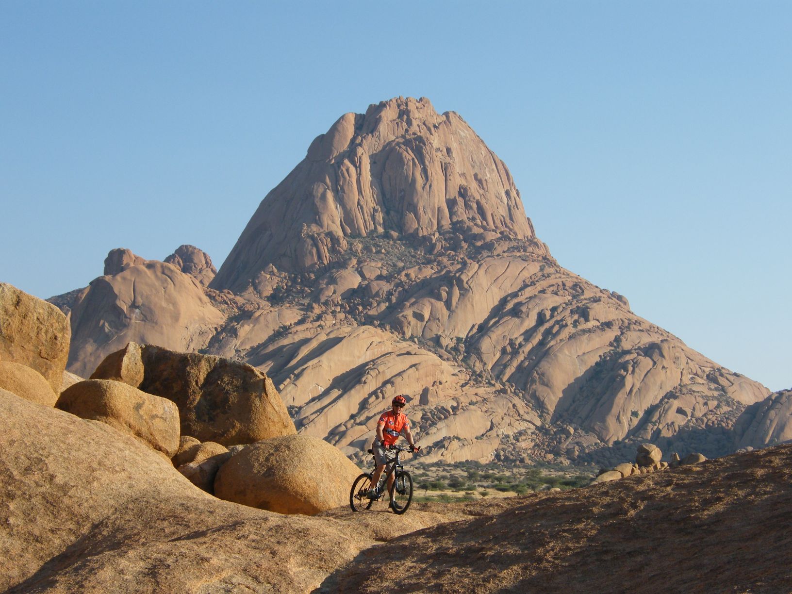 A cyclist on the Spitzkoppe, the "Matterhorn of Namibia"