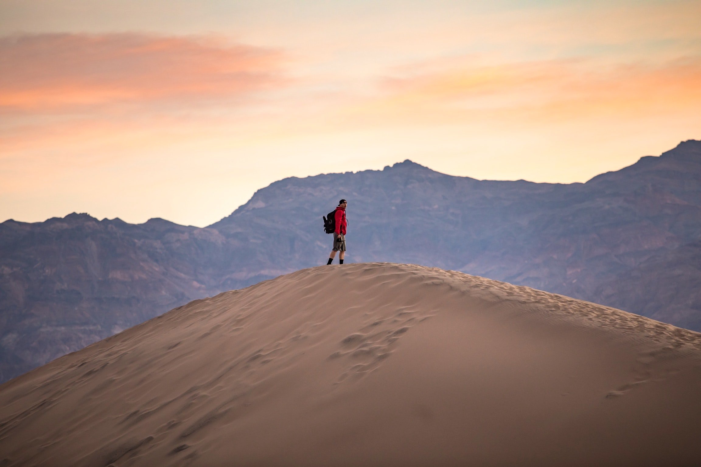 Male hiker on a sand dune in Death Valley, USA