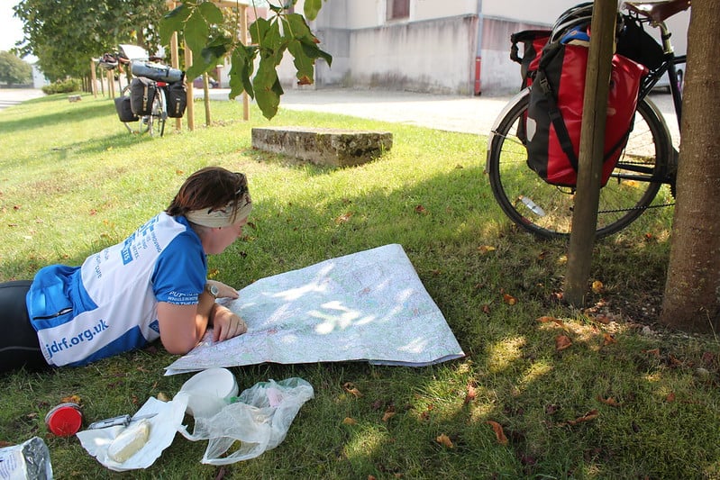 Route planning on the grass, mid cycle tour. Photo: Laura Moss