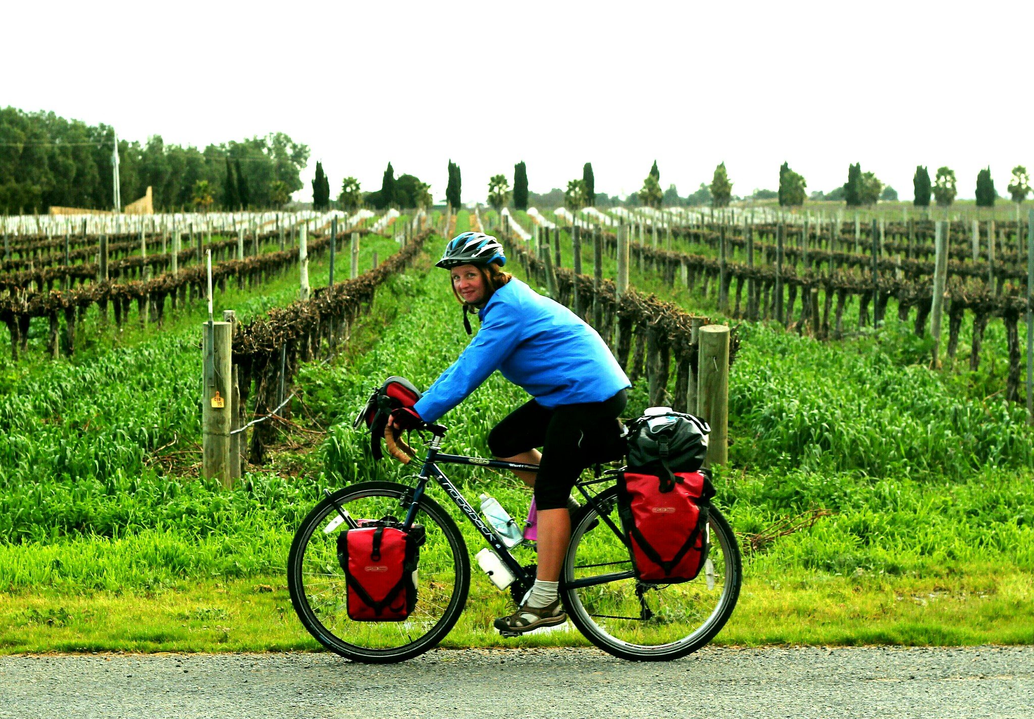 Laura Moss cycling through vineyards in Australia. 