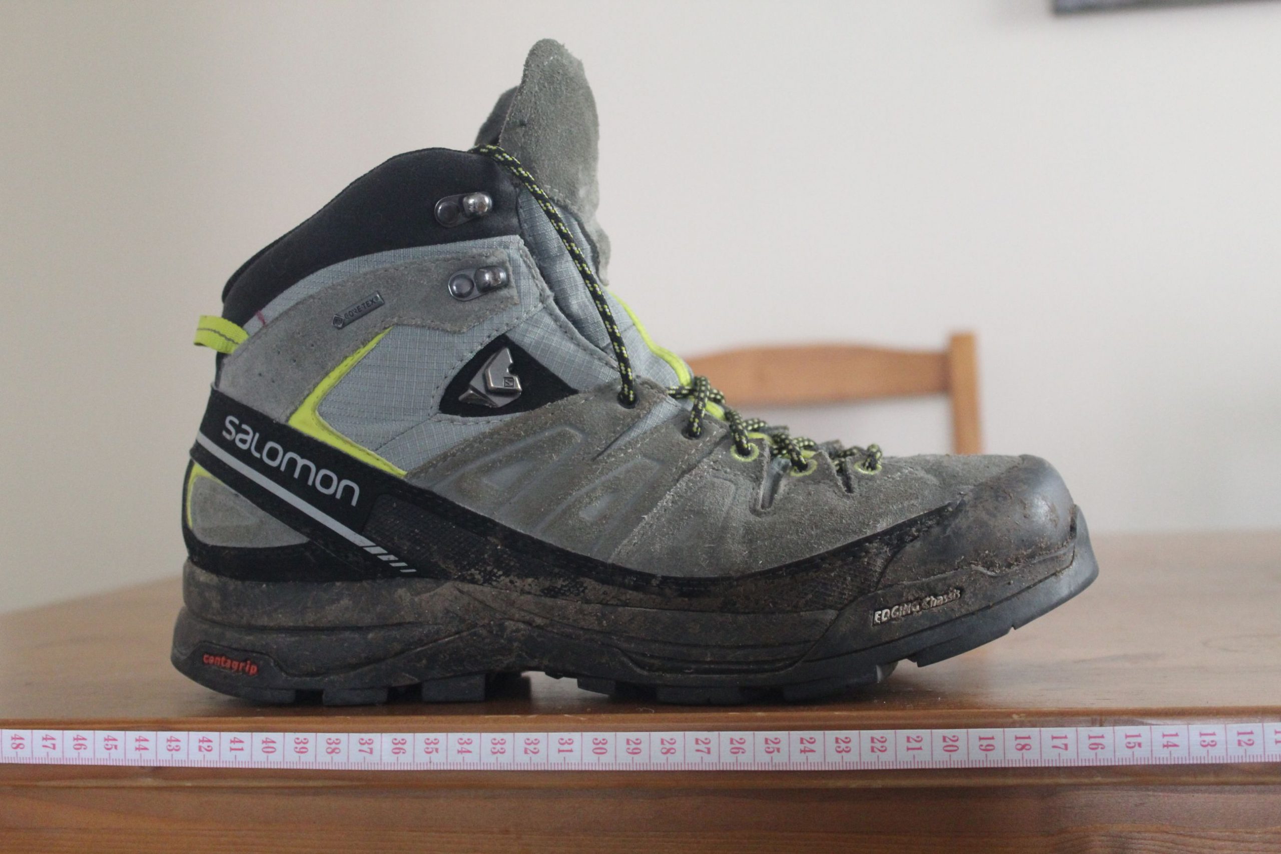A hiking boot with a measuring tape below.