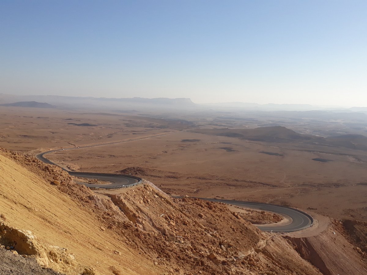 A remote road curving through a mountain landscape.