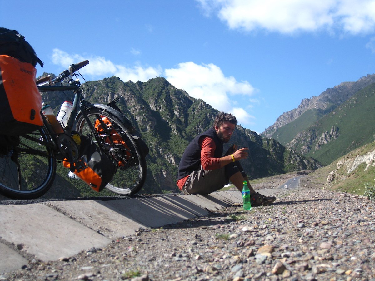 Julian Sayarer stops for a break on a cycle tour