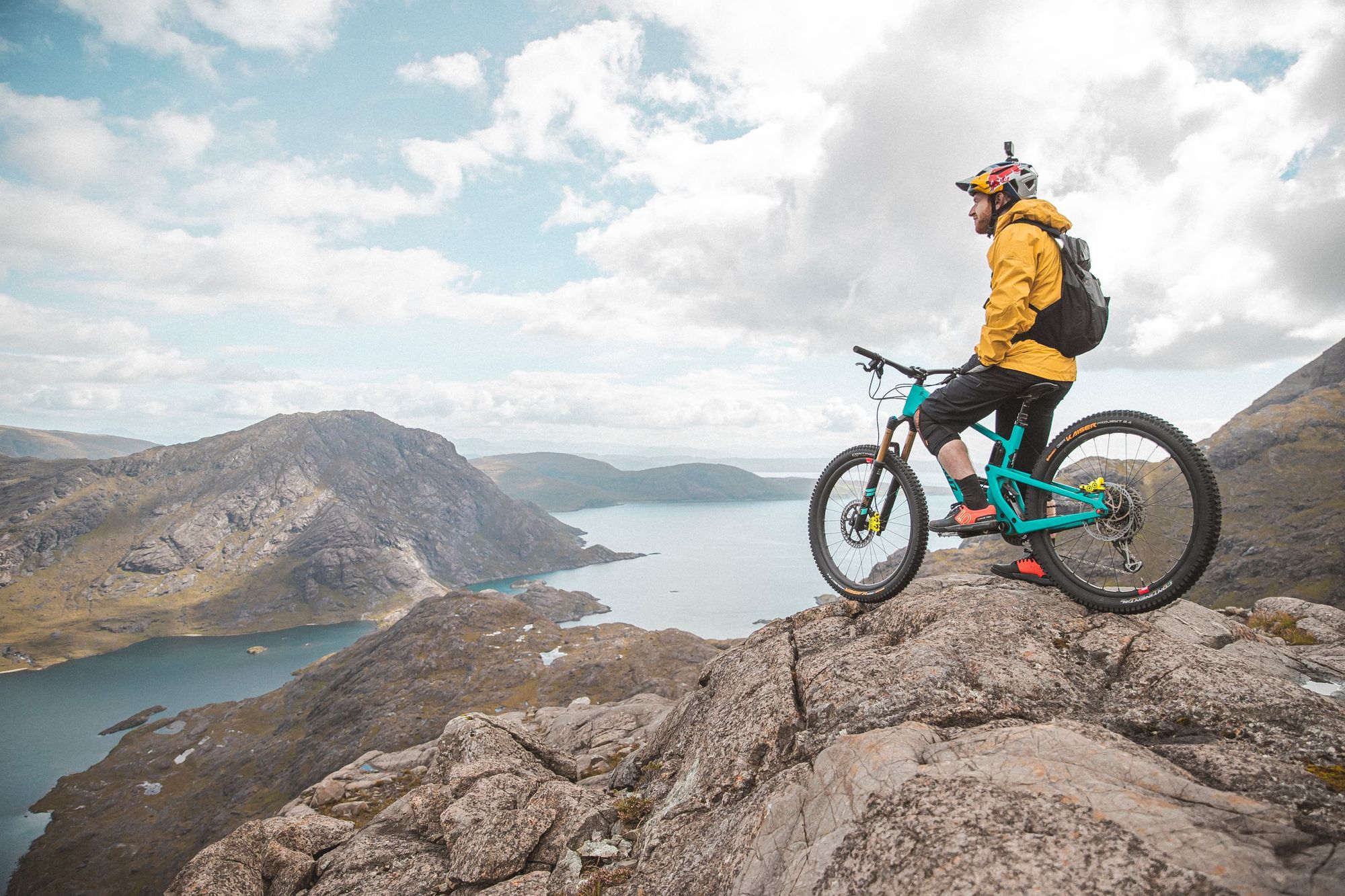 Danny MacAskill looking out on Loch Coruisk, sitting on his mountain bike.