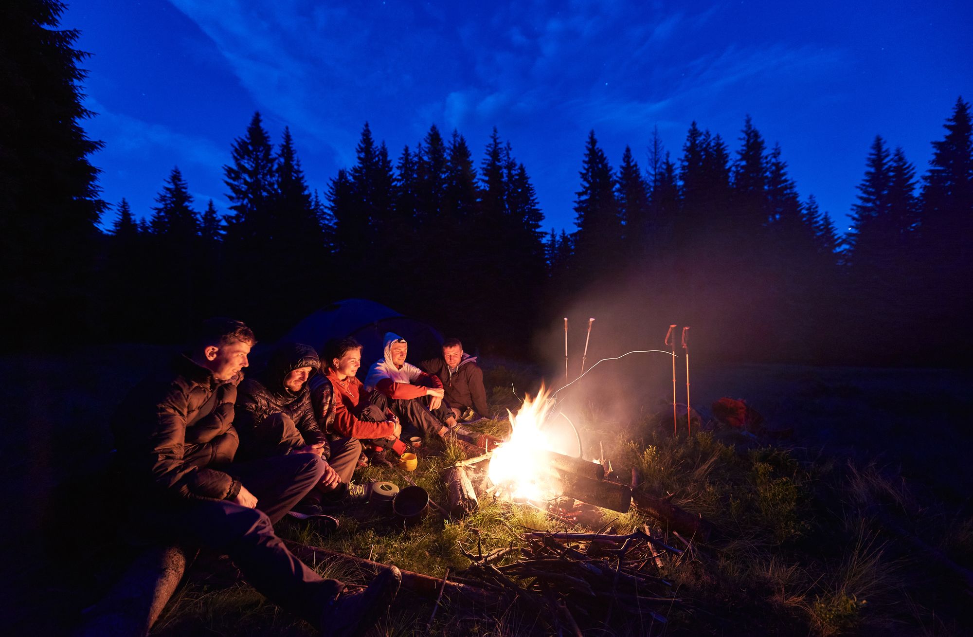 Much Better Adventure club round a campfire.