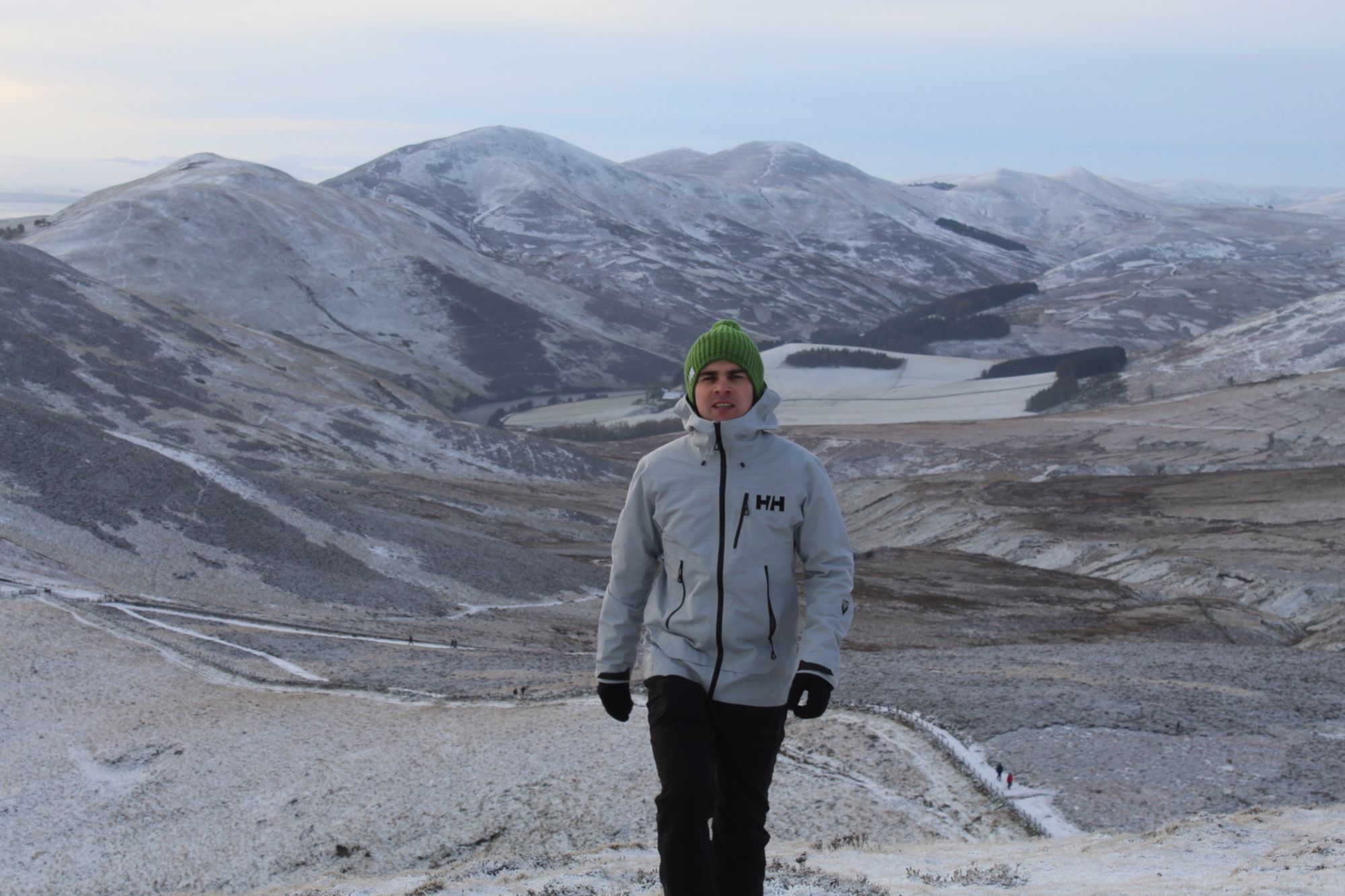 A man hiking in the Pentland hills, wearing Helly Hansen's Odin Mountain Infinity Shell