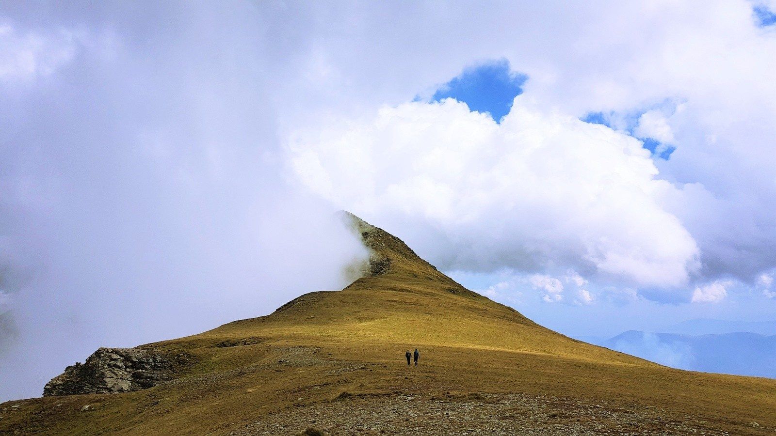 Two hikers making their way up 'The Edge', a mountain in Kosovo.