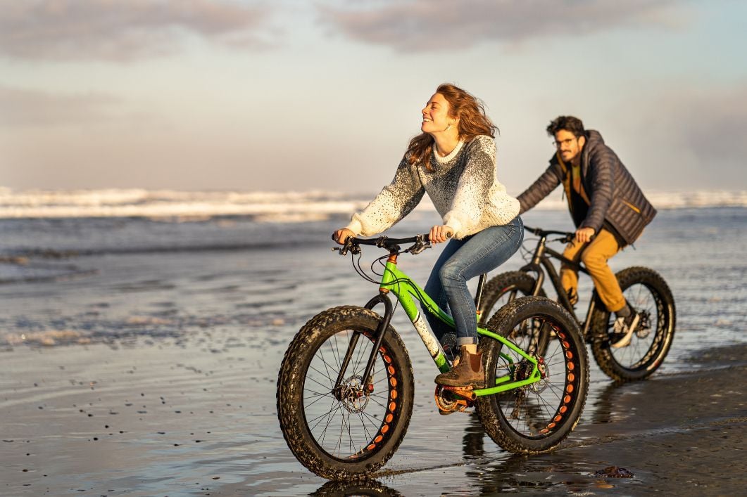 A young couple riding fat bikes