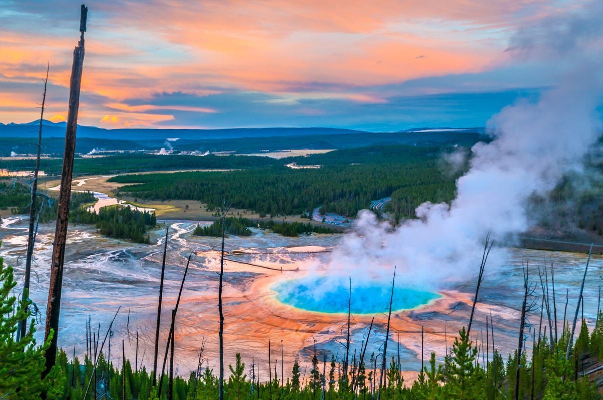 The Grand Prismatic Geyser at sunset, photographed from a hill above