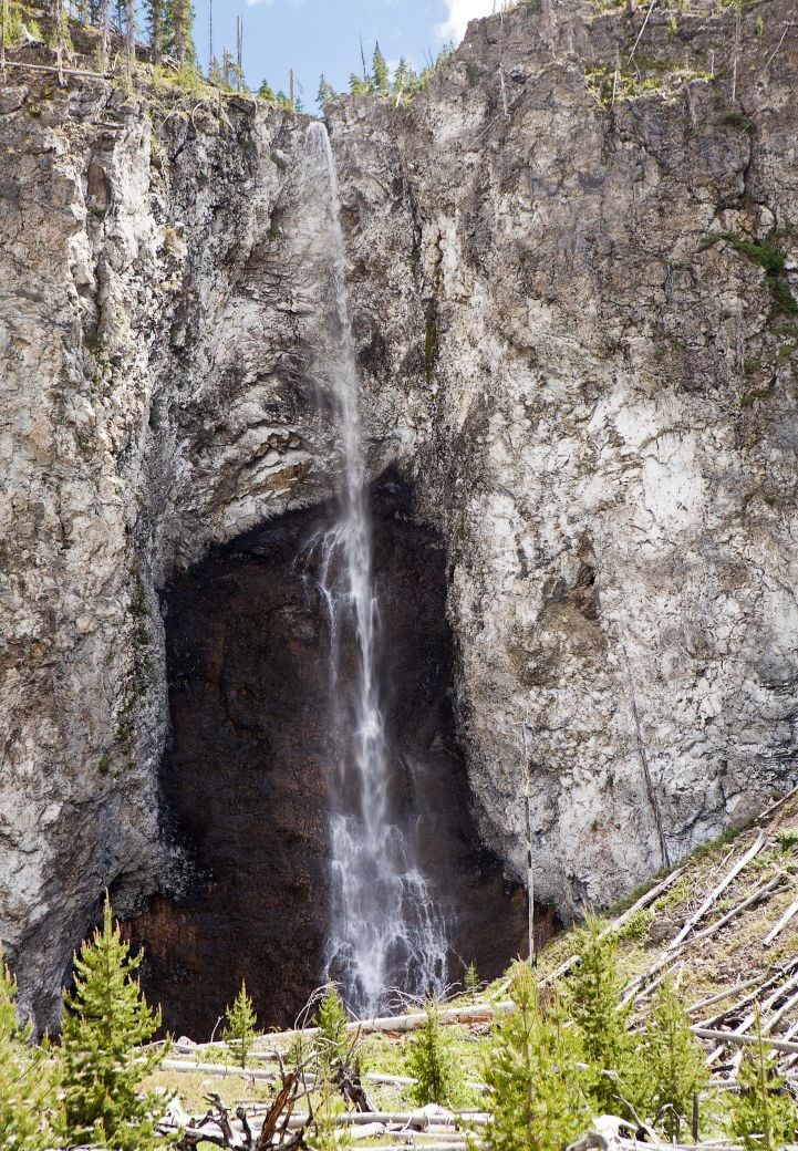 Fairy Falls in Yellowstone National Park is a tall waterfall with a relatively small stream