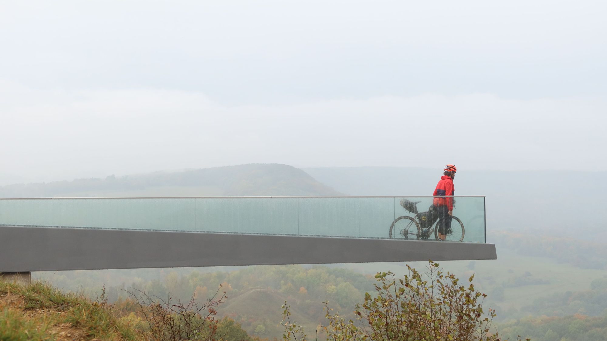 A cyclist looking out at the countryside near the former Iron Curtain in Germany.