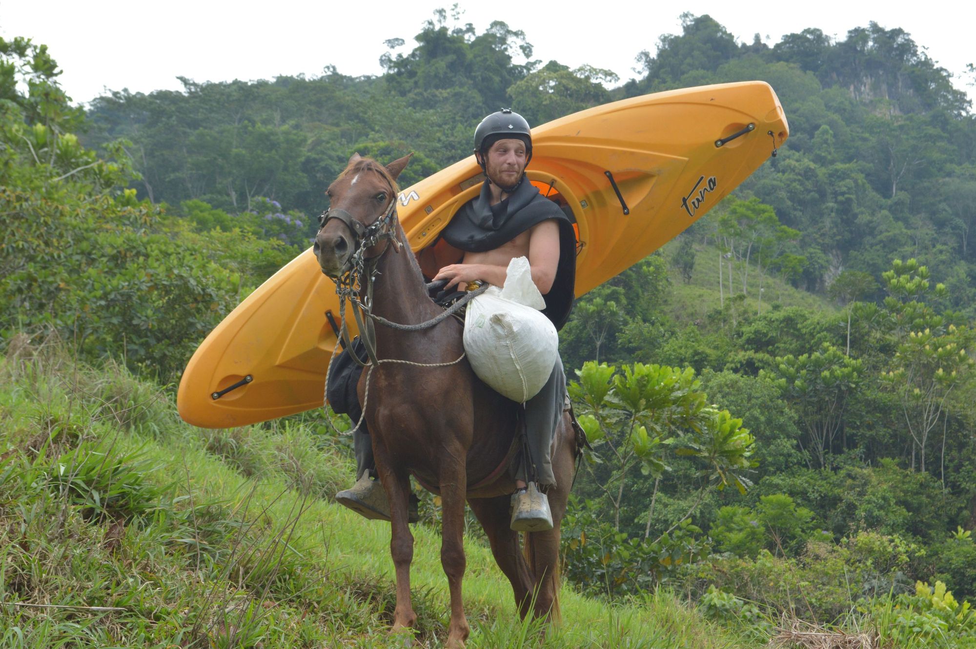 French hydrologist and guide Jules Domine, transporting a kayak while on horseback.