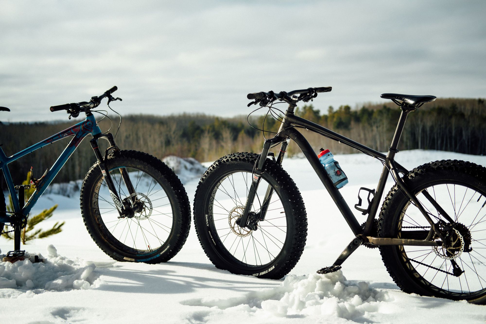 A close-up of two fat bikes in the snow
