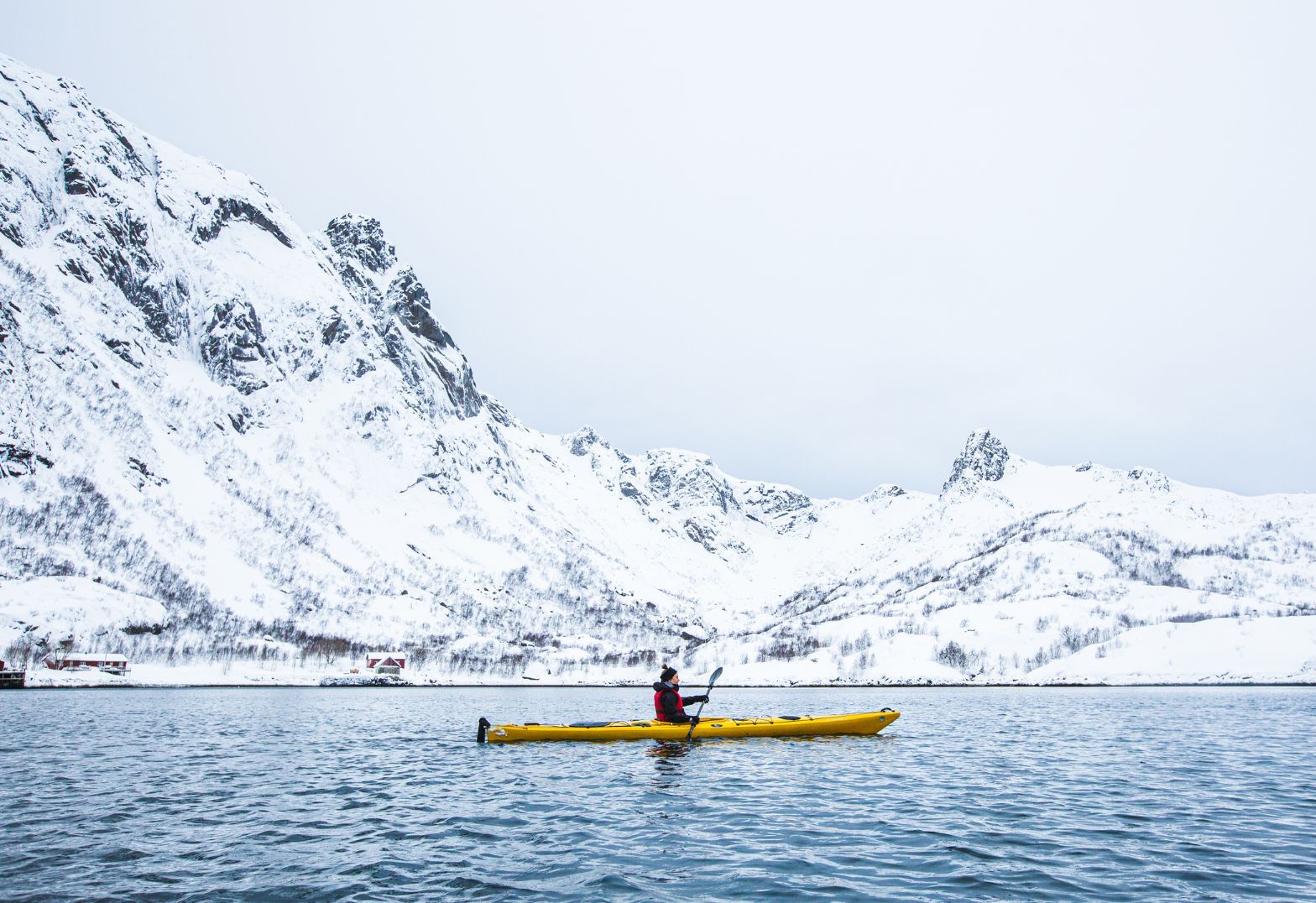 Winter kayaking in a fjord by the Lofoten Island