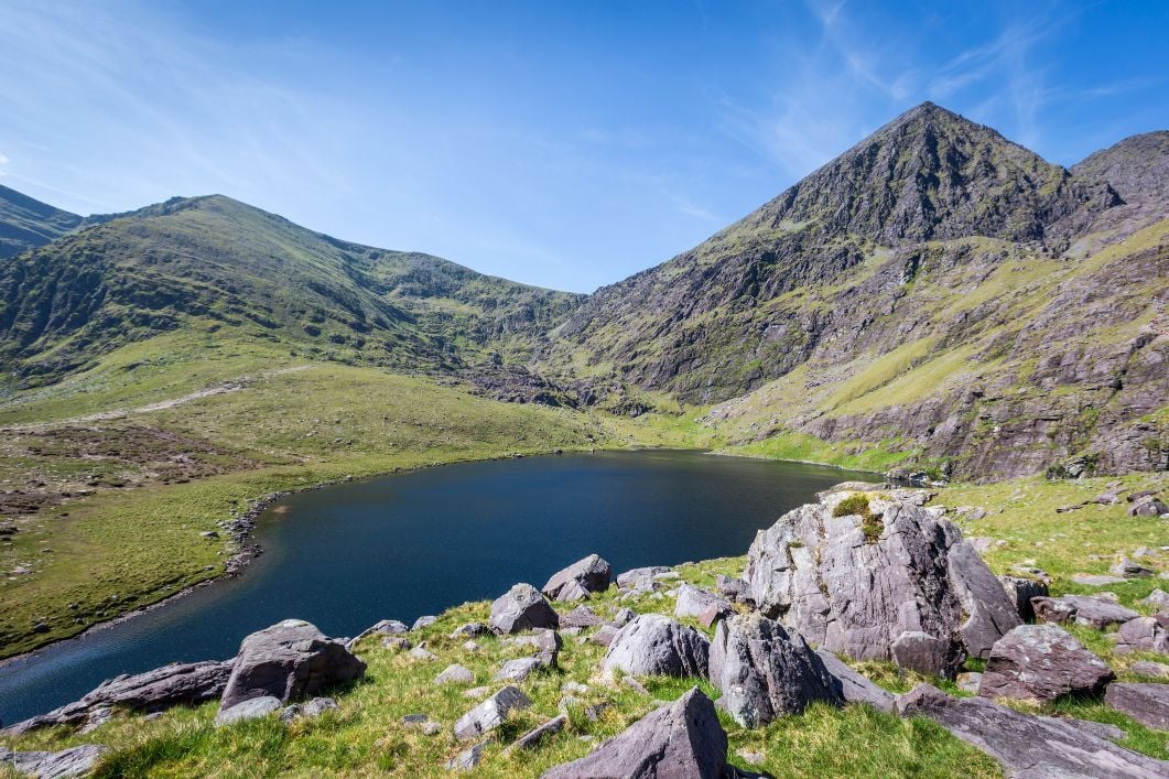 Coomloughra Lough, looking up at Carrauntoohil and the Coomloughra Horseshoe ridgeline in Ireland.
