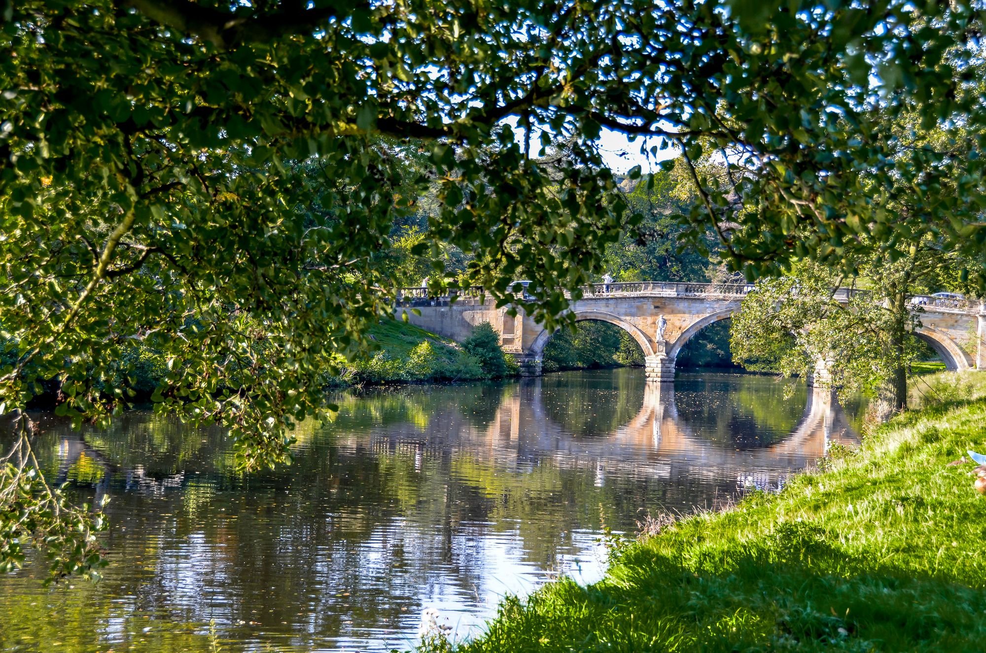 Stately bridge across the river in Chatsworth Estate, on a lush river in the Peak District.