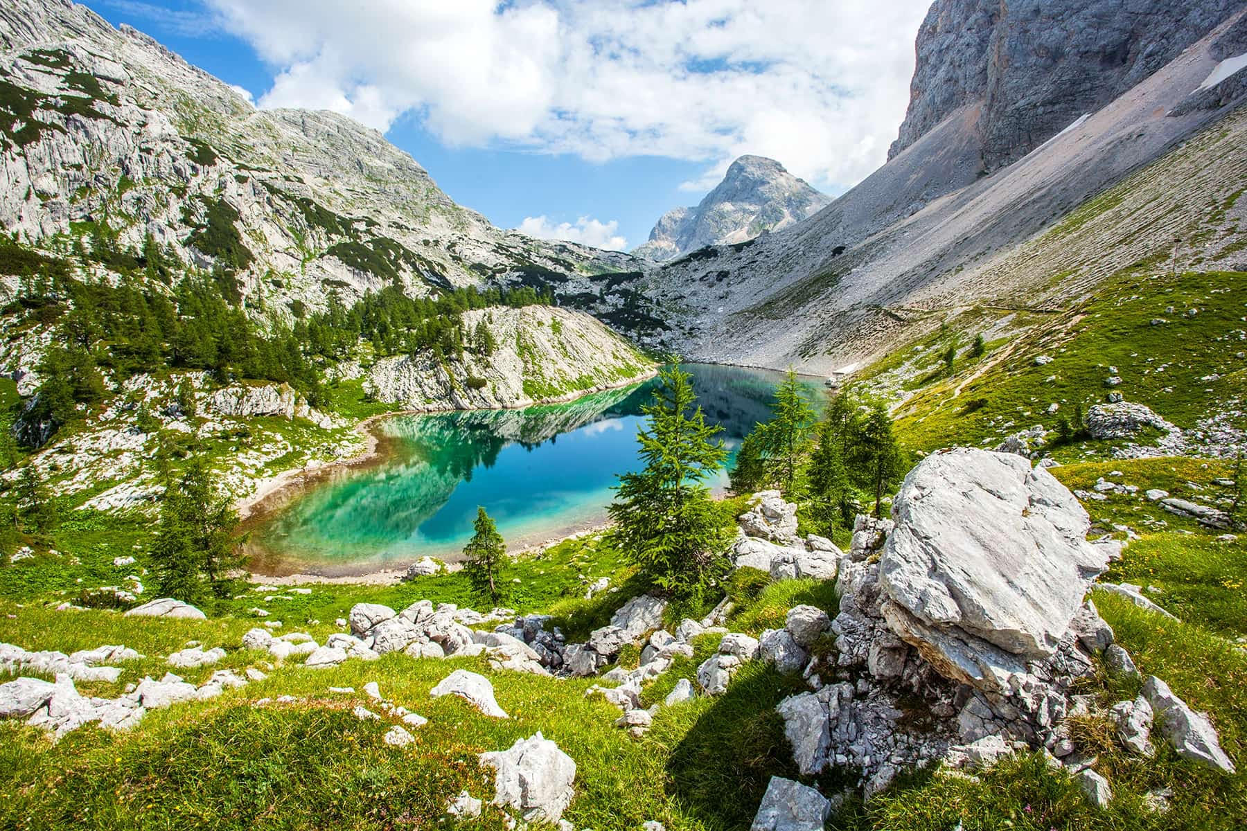 Just one of the turquoise lakes in the high peaks of the Julian Alps. Photo: Getty