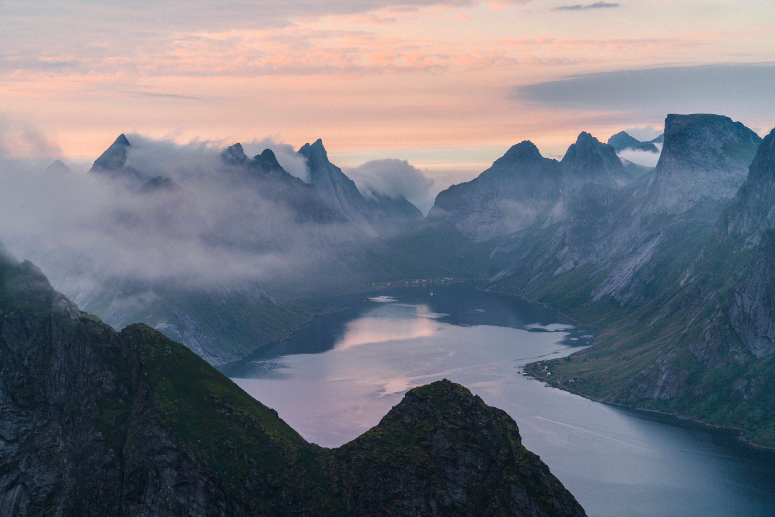 The fjords of Norway, with walls rising high around a sea inlet. 