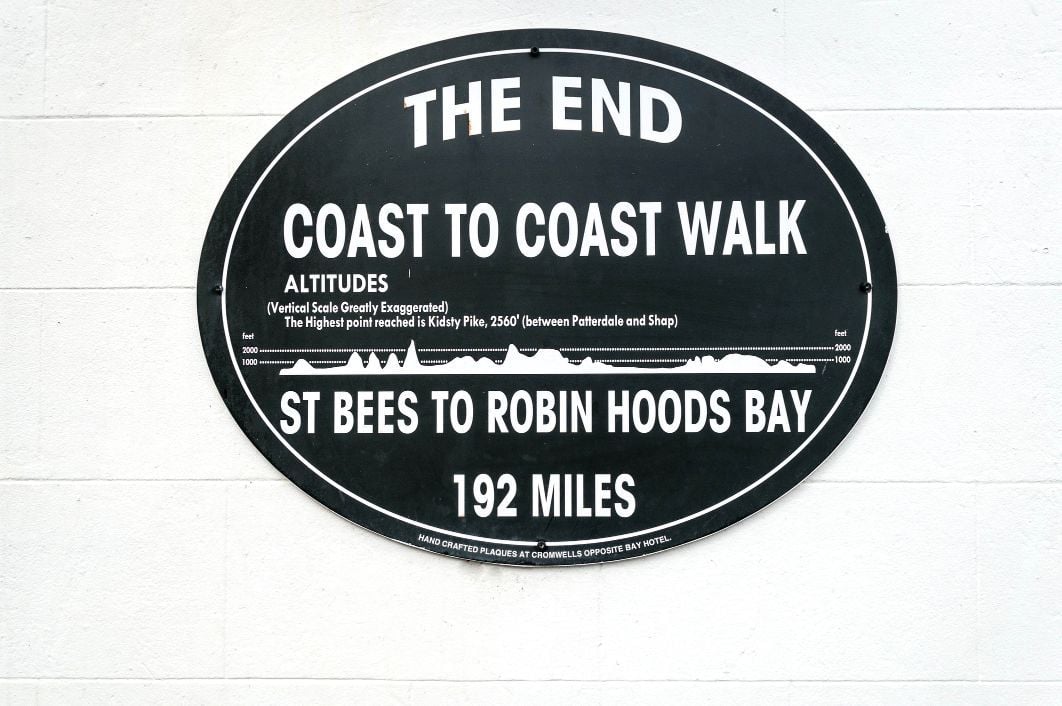 A plaque marking the end point of Wainwright's coast to coast walk at Robin Hoods Bay. 